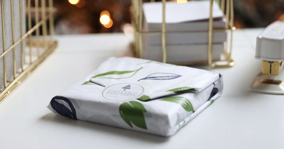 Gift-wrapped coaster puzzle from Smiling Tree Gifts on white desk